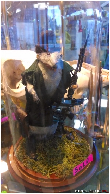 DEAD RAT HOLDING GUN