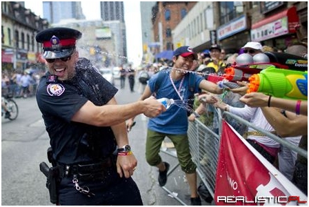 Cop shot in the head while returning fire on a crowd of people