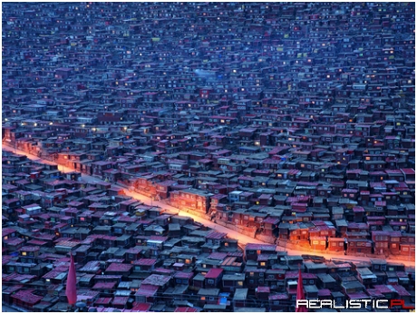 Street lights pop near small homes with red roofs in Larung Gar,
